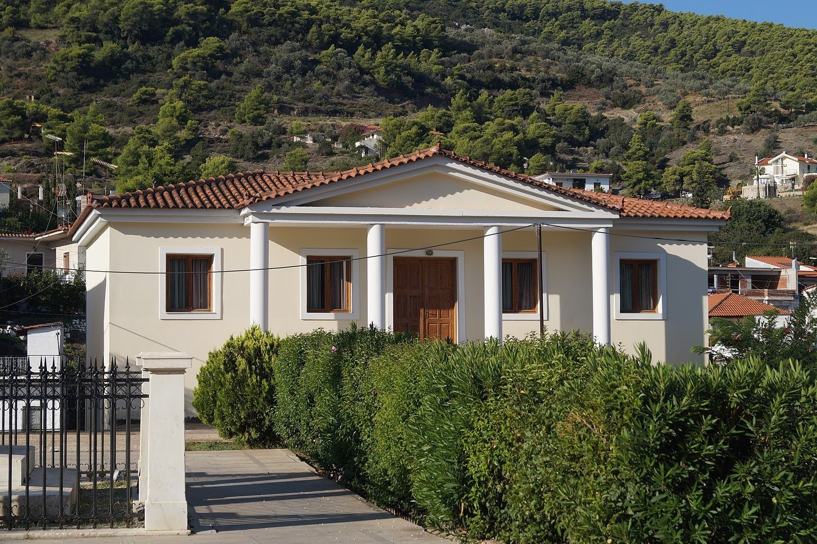 Small Mediterranean-style Building with a Low-Sloped-Hip Roof